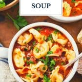 Italian sausage tortellini soup with text title overlay.