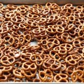 Spreading pretzels on a baking sheet.
