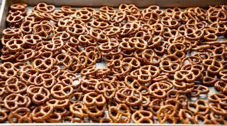 Spreading pretzels on a baking sheet.