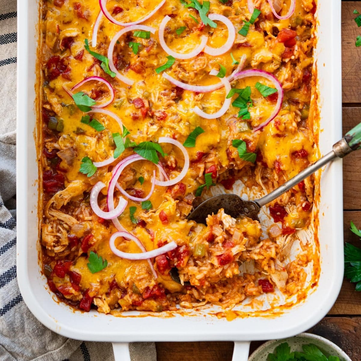 Square overhead shot of chicken fajita casserole in a white dish.