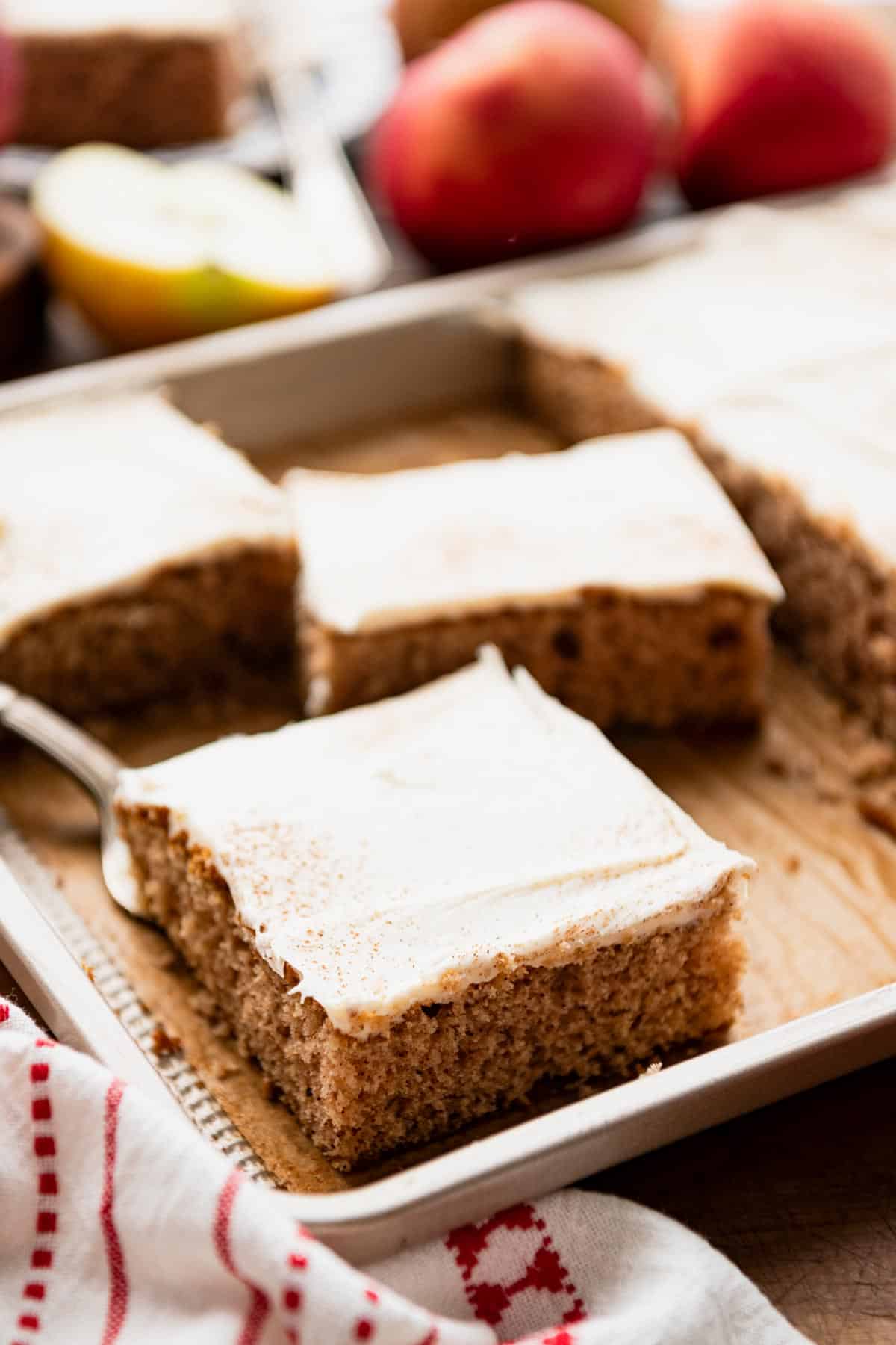 Applesauce bars with cream cheese frosting in a baking pan.