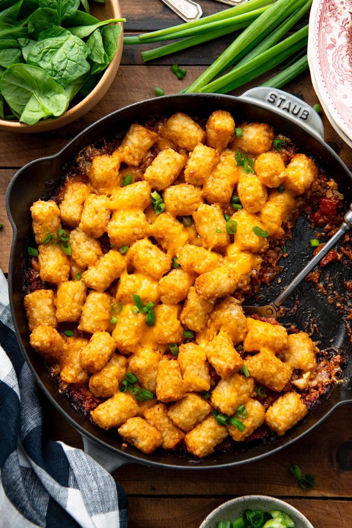 Overhead shot of cheeseburger tater tot casserole in a cast iron skillet.