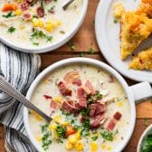 Two bowls of an easy chicken corn soup recipe served with a side of cornbread.