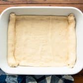 Crescent dough sheet in a baking dish.