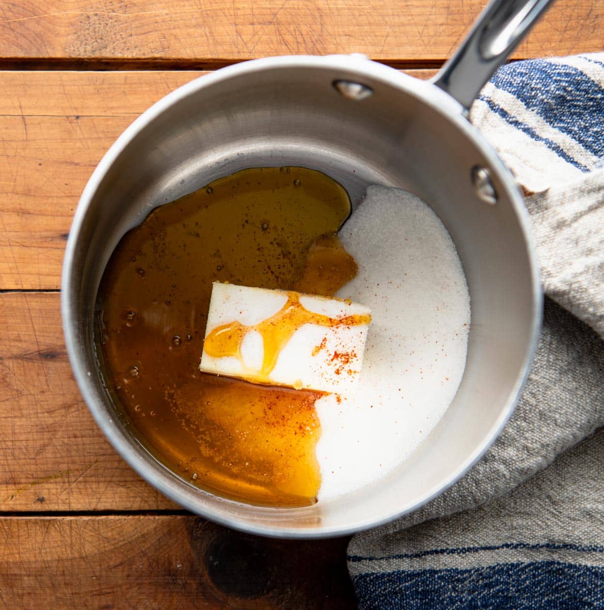 Overhead image of honey butter sauce ingredients in a saucepan.