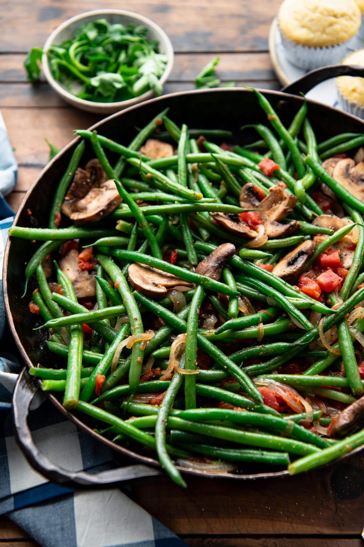 Easy green beans and mushrooms recipe in a cast iron skillet.