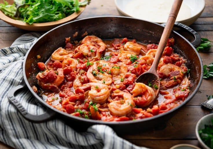 Horizontal image of a pan of shrimp in tomato gravy.