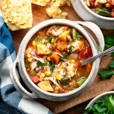Square overhead image of a bowl of turkey vegetable soup.