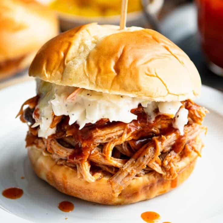Crock pot beer pulled pork on a sandwich roll with coleslaw.