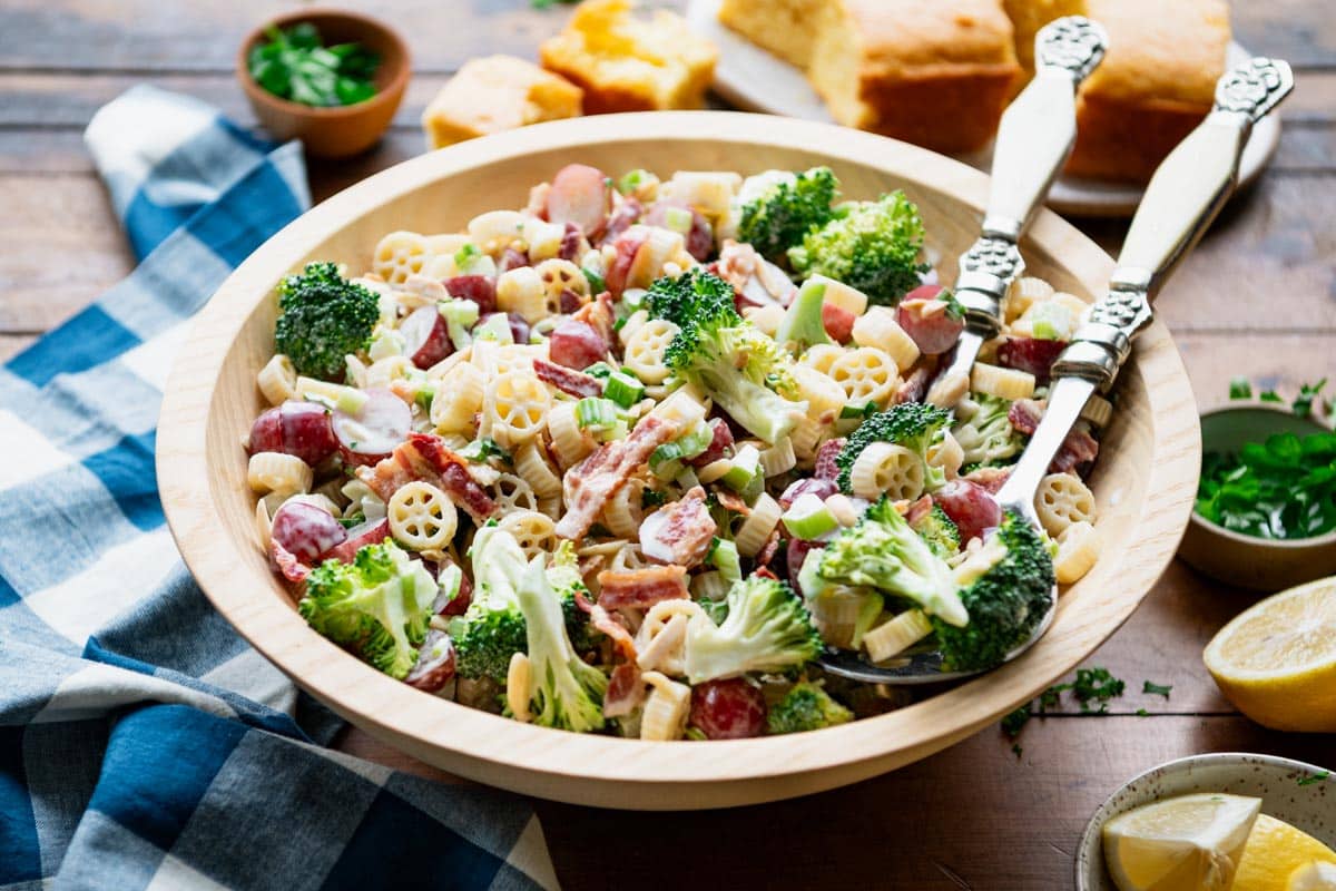 Horizontal side shot of a bowl of broccoli and grape pasta salad.