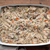 Chicken and wild rice casserole in a dish before adding topping and baking.