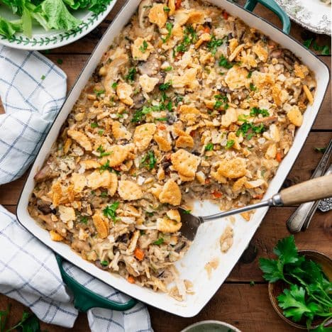 Square overhead shot of chicken and wild rice casserole on a wooden table.