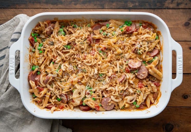 Overhead shot of sausage noodle bake with onions and cheese on the top.