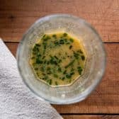 Homemade vinaigrette in a glass jar.