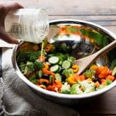 Process shot showing how to make a marinated vegetable salad.