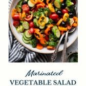 Marinated vegetable salad with text title at the bottom.