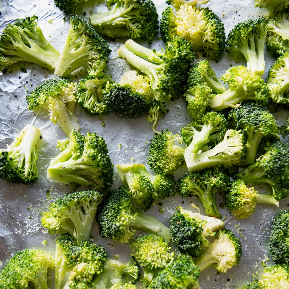 Close up shot of broccoli on a sheet pan.