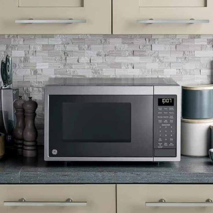 Square side shot of a small microwave on a countertop.