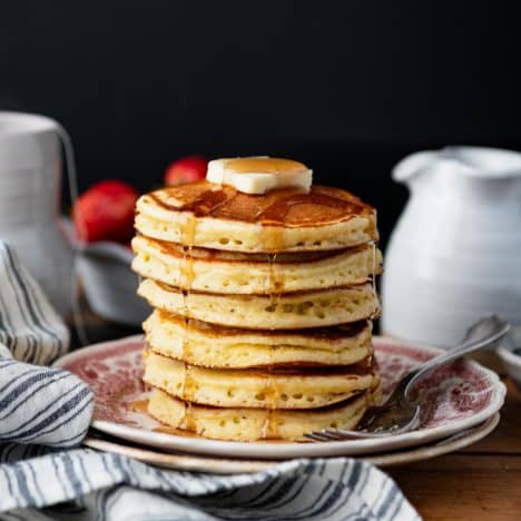 Square side shot of butter and syrup on a stack of Jiffy cornbread pancakes.