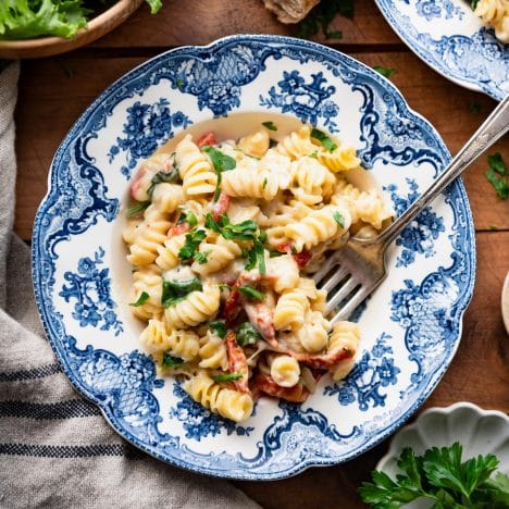 Square overhead shot of a bowl of creamy Tuscan chicken pasta.