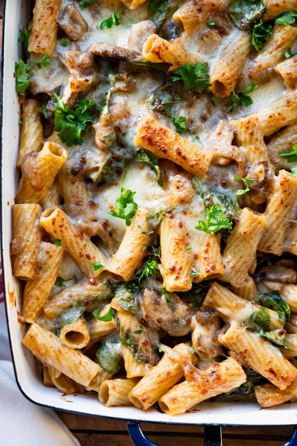 Close up shot of French onion pasta casserole in a baking dish.