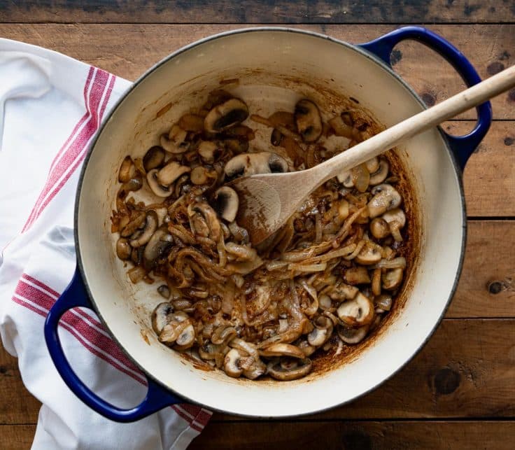 Caramelized onions and mushrooms in a skillet.