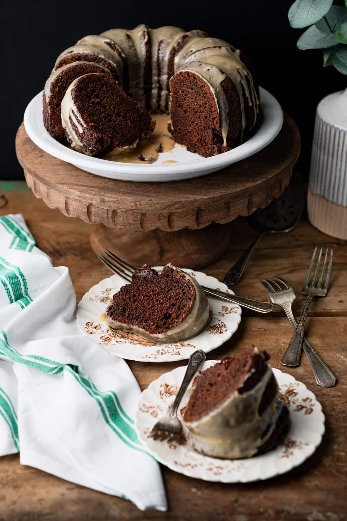 Two slices of guinness chocolate Bundt cake on a wooden table.
