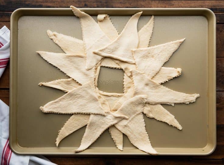 Arranging crescent rolls on a baking sheet.