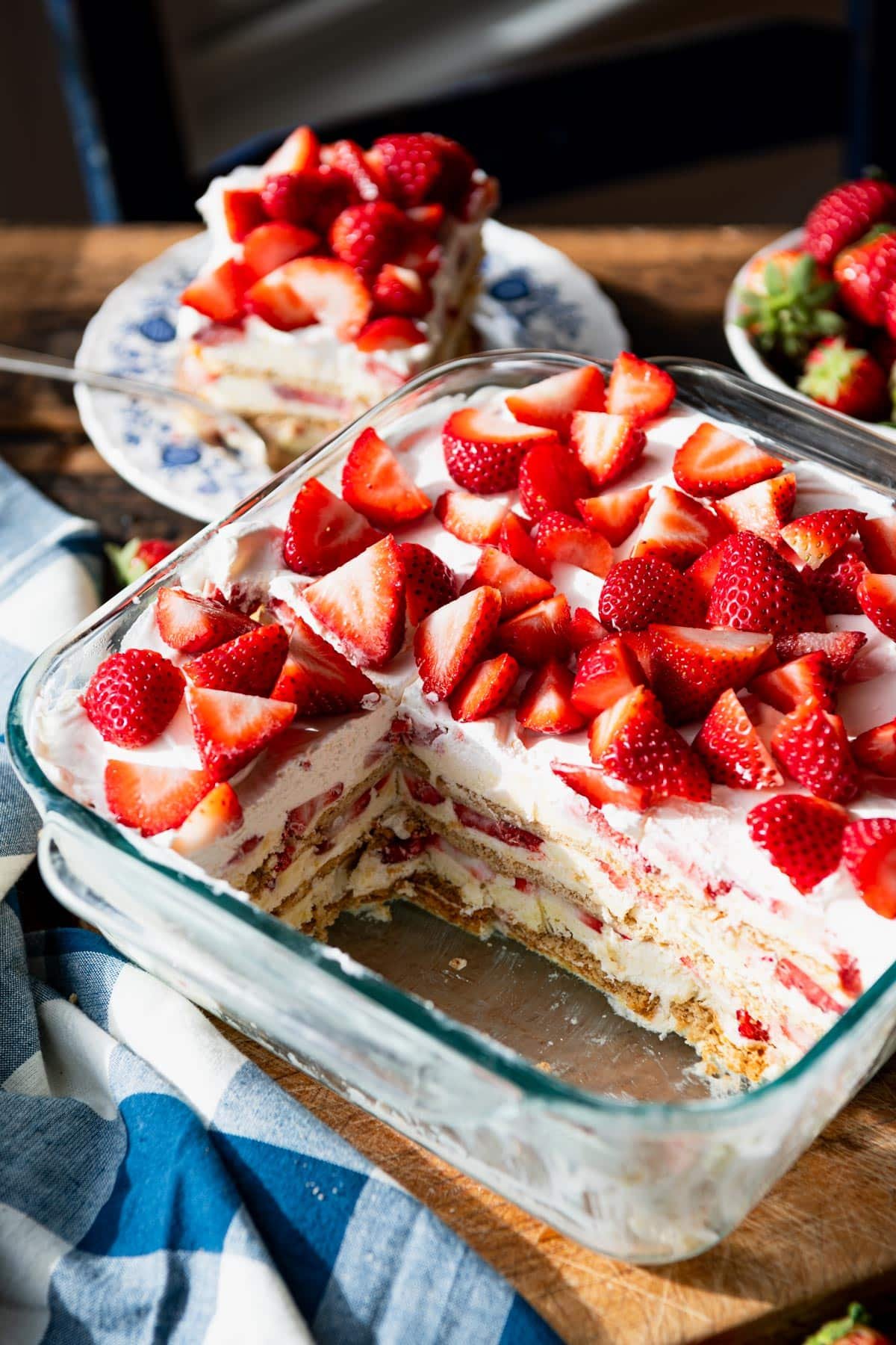 Close up side shot of a glass dish full of the best strawberry cream cheese icebox cake recipe.