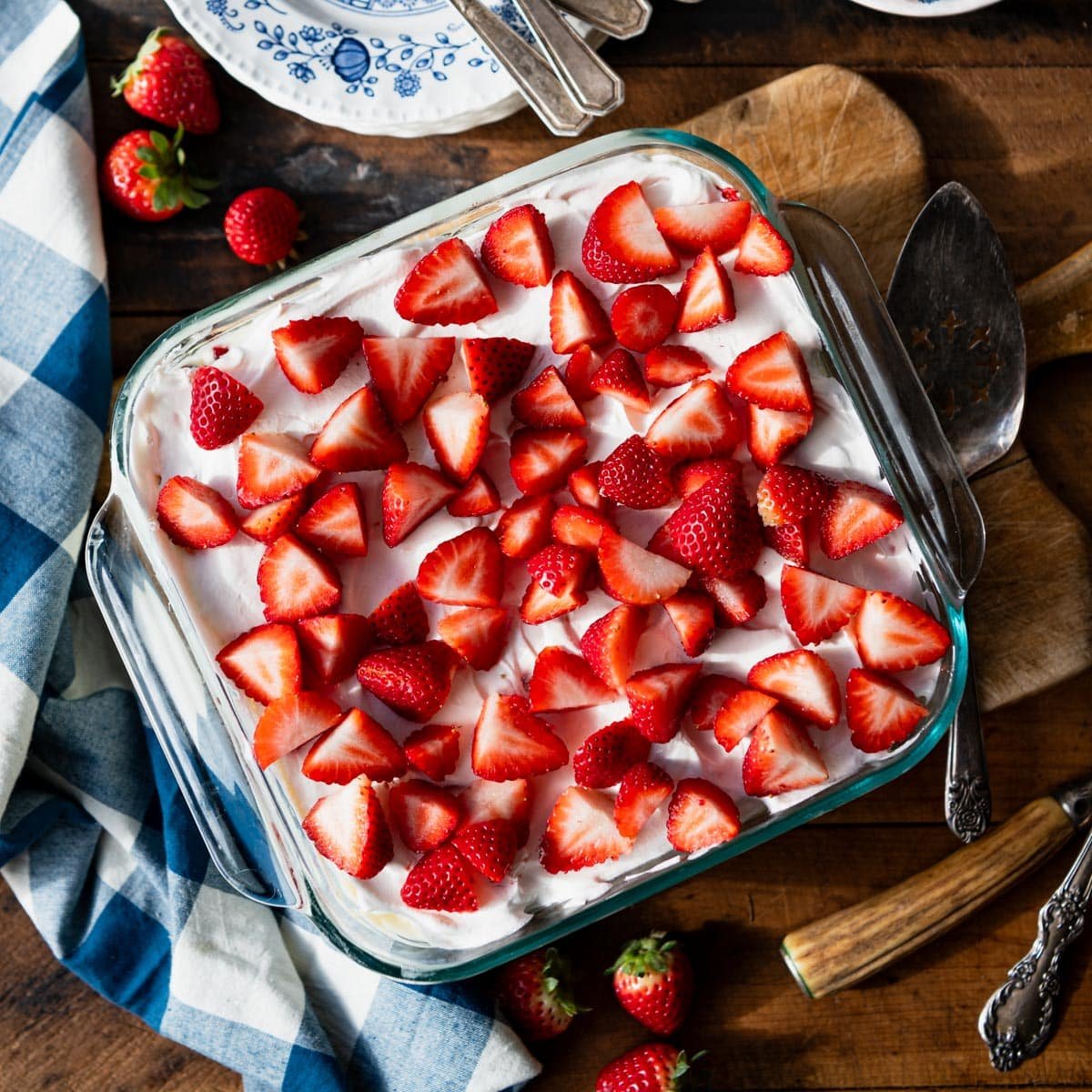 Overhead image of a square glass dish full of the best strawberry icebox cake with pudding.