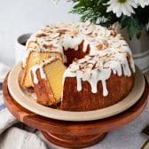 Square side shot of the best almond pound cake recipe served on a wooden cake stand.