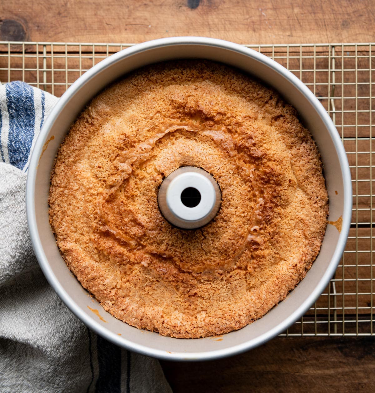 Pound cake in a tube pan on a cooling rack.