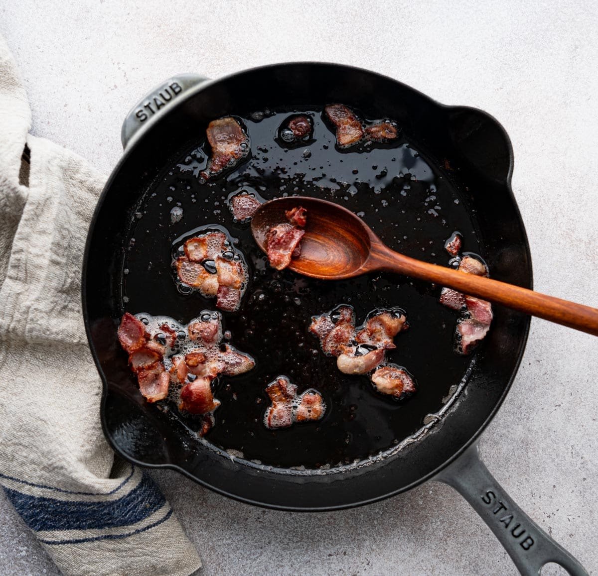 Frying bacon in a cast iron skillet.
