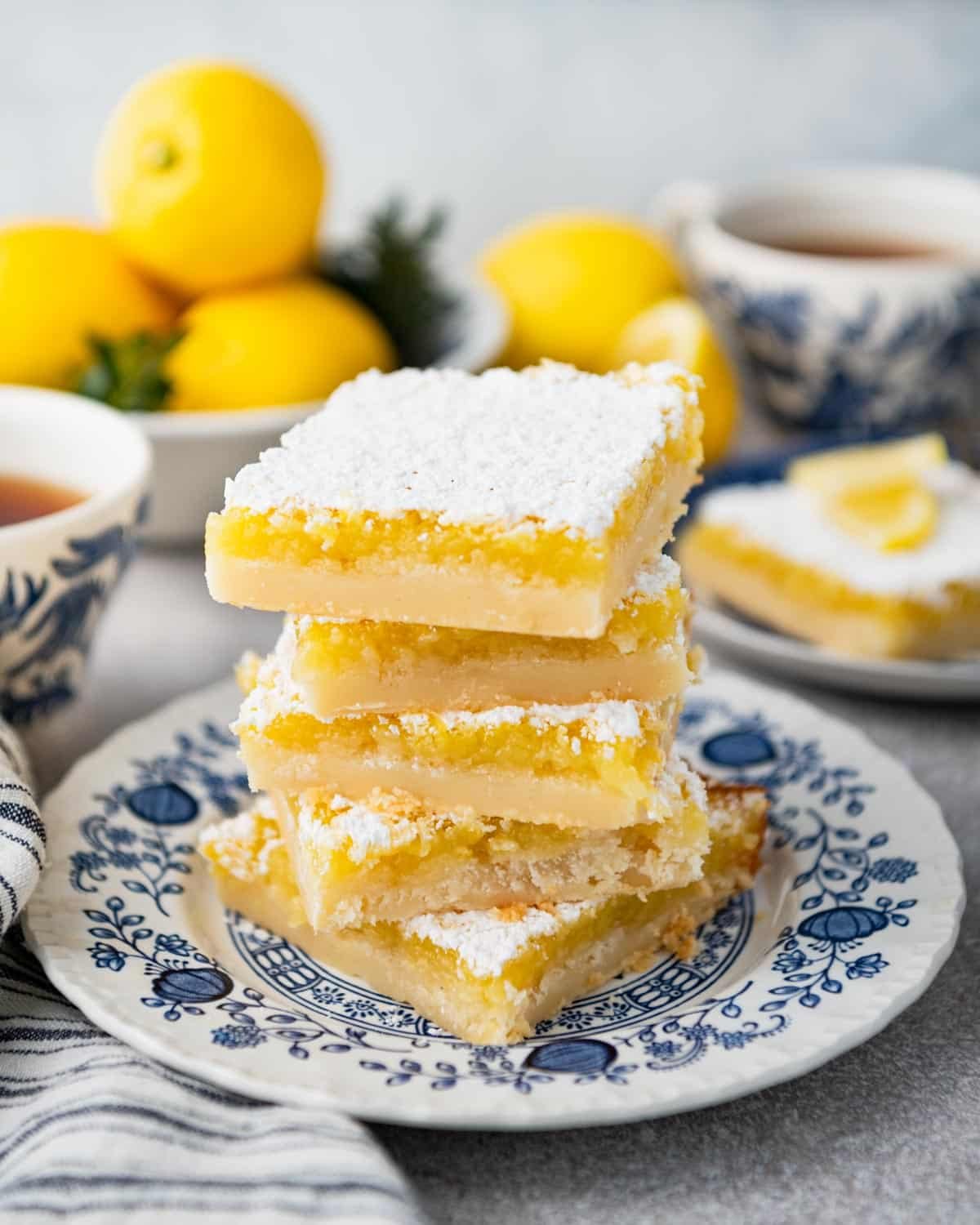 Side shot of an easy lemon squares recipe served on a blue and white plate.