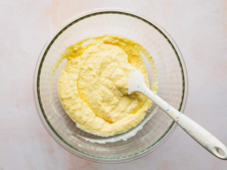 Adding remaining milk to the pudding mixture.