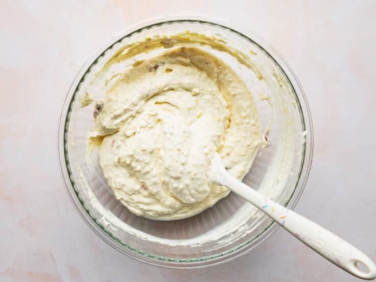 Folding the whipped cream into the pudding mixture.