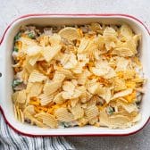Tuna casserole with noodles in a baking dish before it goes in the oven.