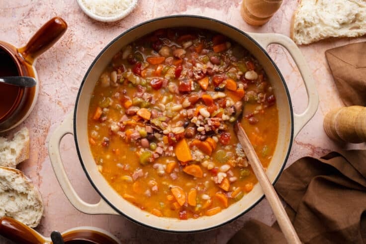 Horizontal overhead shot of ham and bean soup in a Dutch oven.