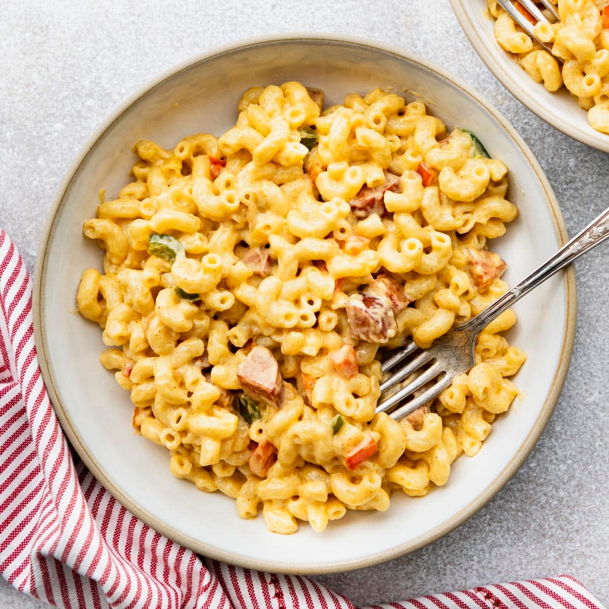 Square overhead shot of a white bowl full of cajun mac and cheese.