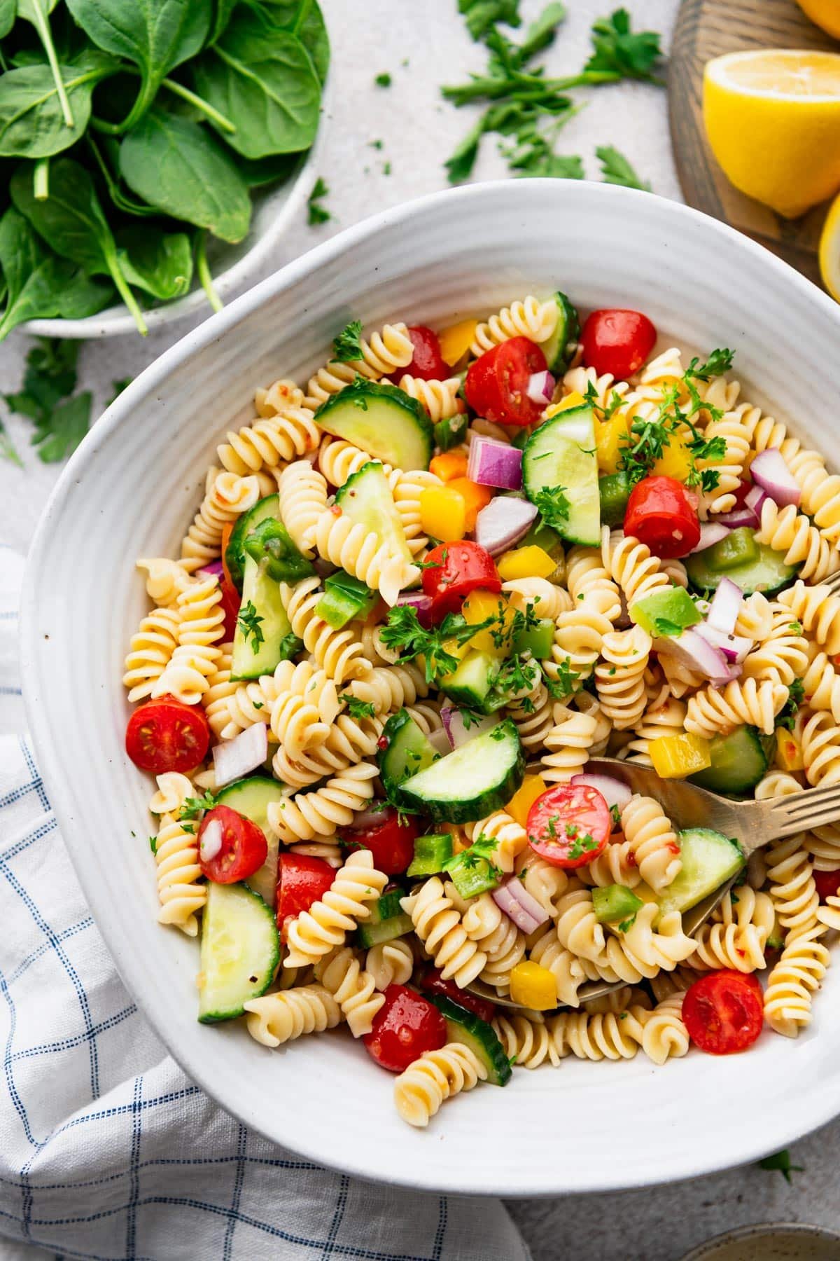 Close overhead shot of a classic pasta salad recipe served in a white bowl.