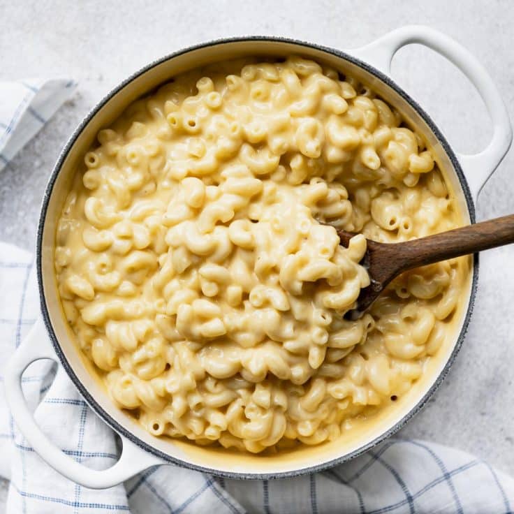 Square overhead shot of a simple Dutch oven mac and cheese recipe on a white table.