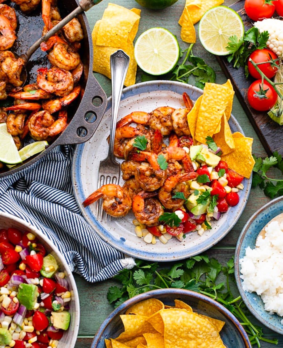 Overhead image of Mexican shrimp on a green table with sides.