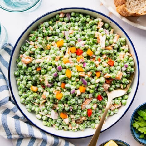 Square overhead shot of a bowl of English pea salad.