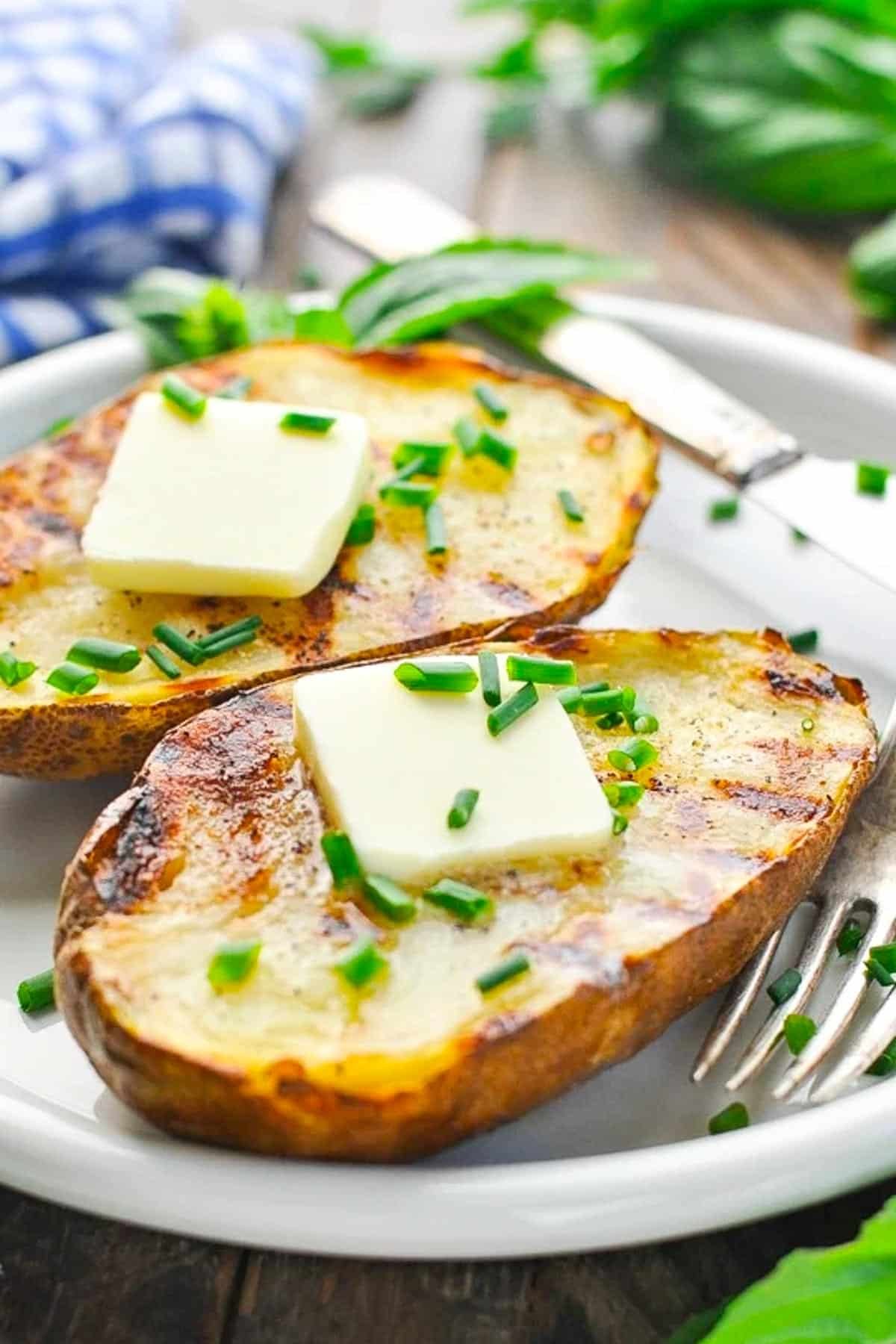 Grilled potatoes on a white plate for a collection of potato side dishes.