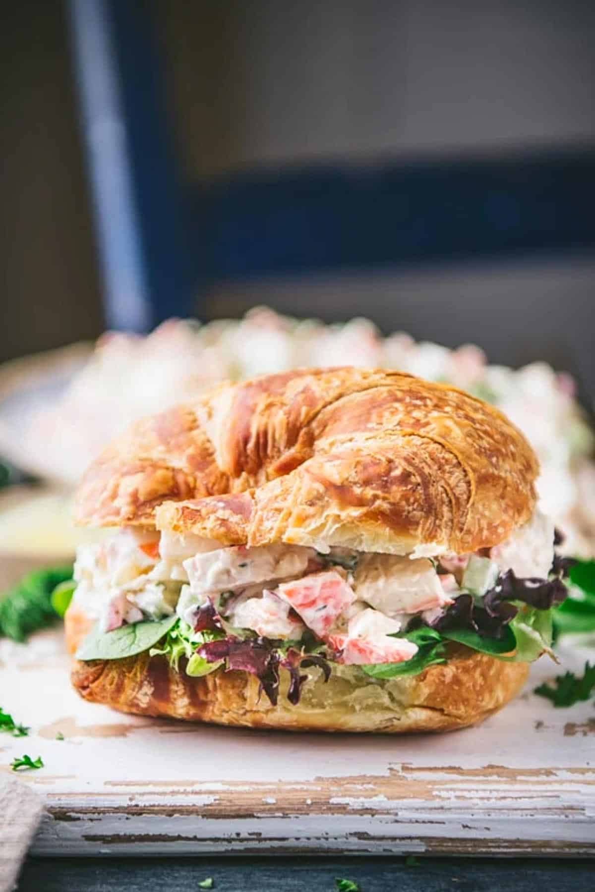 The best seafood salad recipe served on a croissant sandwich.
