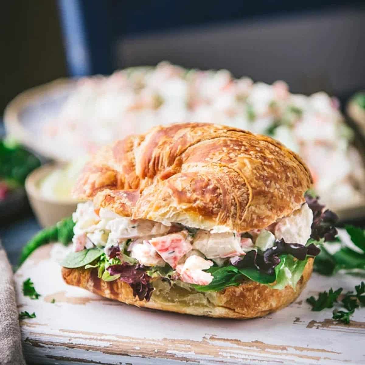 Square side shot of classic seafood salad on a croissant.