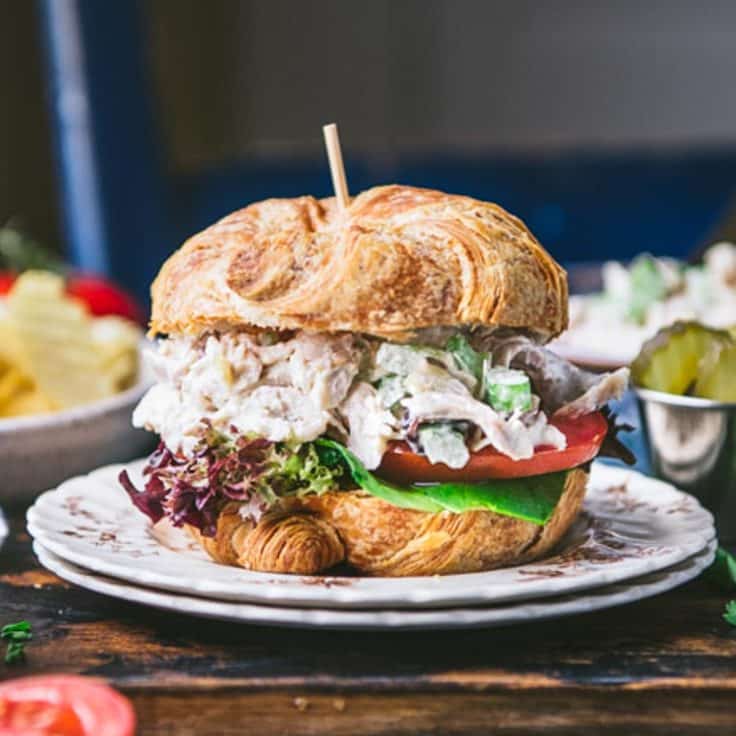 Square side shot of the best chicken salad sandwich on a croissant.