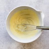 Whisking mayonnaise dressing for potato salad.