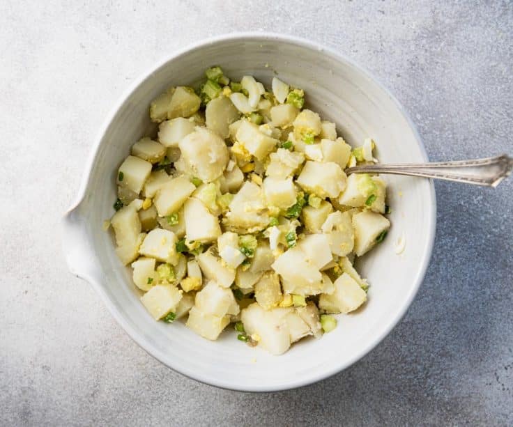 Stirring together ingredients for southern potato salad.