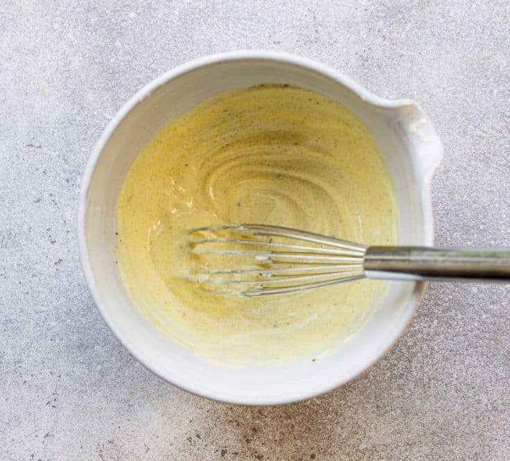 Whisking mayonnaise dressing for potato salad.